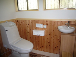 既設再用の便器と手洗器の色を合わせ、杉板を張って和風テイストのトイレに仕上げました。